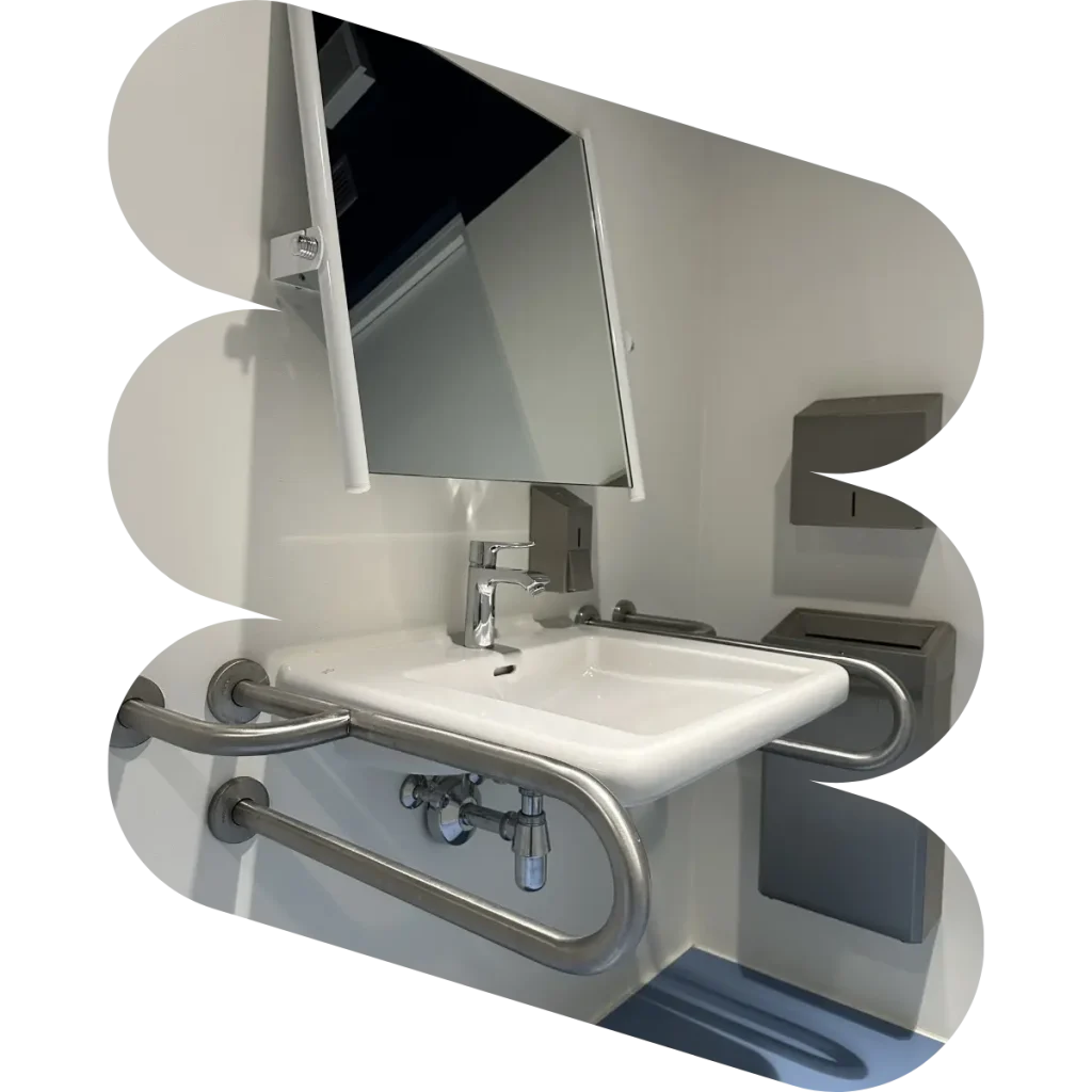 Accessible bathroom. Sink with handrails and adjustable mirror